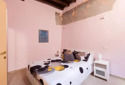 a bedroom with a cow print bed in a room at Boccanera a Trastevere Holiday Apartment in Rome