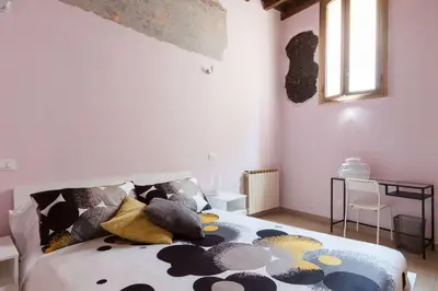a bedroom with a bed with black and white pillows at Boccanera a Trastevere Holiday Apartment in Rome