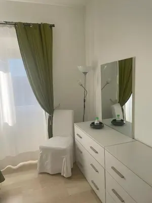 a bedroom with a dresser with a mirror and a chair at Saint Peter's House in Rome