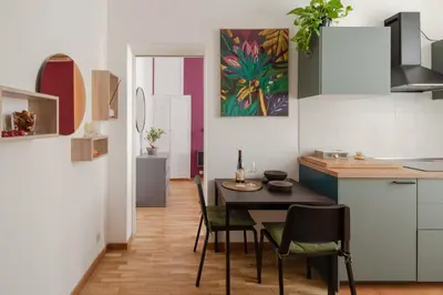 a kitchen and dining room with a table and chairs at La Casa Di Rinny - Vaticano in Rome