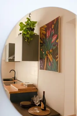 a kitchen with a potted plant on the wall at La Casa Di Rinny - Vaticano in Rome