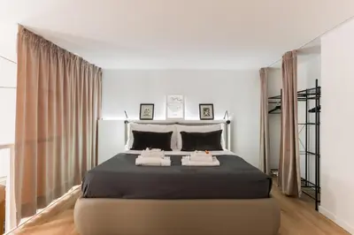 a bedroom with a large bed with two pillows at Locazione turistica via degli spagnoli in Rome