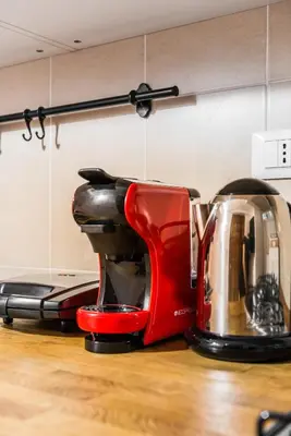 a red toaster sitting on top of a kitchen counter at Locazione turistica via degli spagnoli in Rome