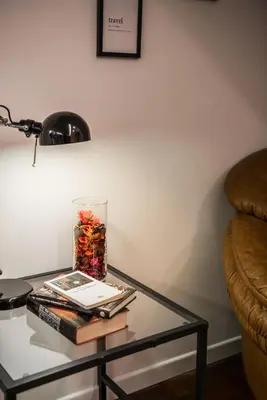 a glass coffee table with books and a lamp at Locazione turistica via degli spagnoli in Rome