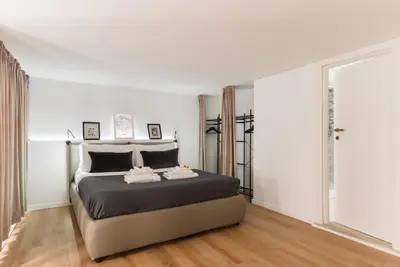 a bedroom with a large bed in a white room at Locazione turistica via degli spagnoli in Rome