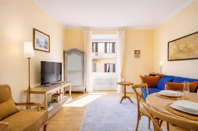 a living room with a blue couch and a table at Elegantis Milos Suite Apartment - Your Chic Retreat in Central Rome in Rome