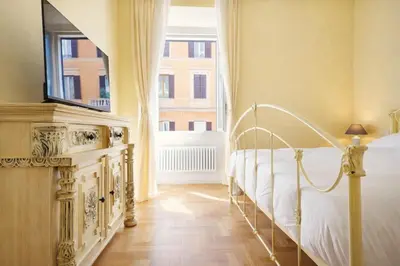 a bedroom with a white bed and a window at Elegantis Milos Suite Apartment - Your Chic Retreat in Central Rome in Rome