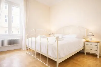 a white bedroom with a white bed and a window at Elegantis Milos Suite Apartment - Your Chic Retreat in Central Rome in Rome