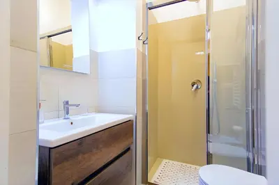 a bathroom with a sink and a shower at Elegantis Milos Suite Apartment - Your Chic Retreat in Central Rome in Rome