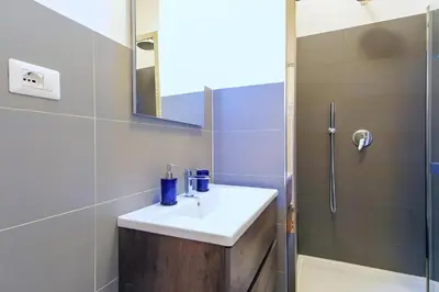 a bathroom with a sink and a shower at Elegantis Milos Suite Apartment - Your Chic Retreat in Central Rome in Rome