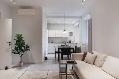 a living room with a white couch and a table at GuestHost - Pannonia Colosseum in Rome
