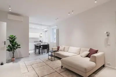 a living room with a couch and a table at GuestHost - Pannonia Colosseum in Rome