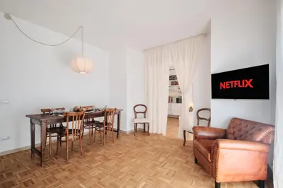a living room with a couch and a table and chairs at Basilica San Paolo - Luxurious penthouse with Wi-Fi in Rome