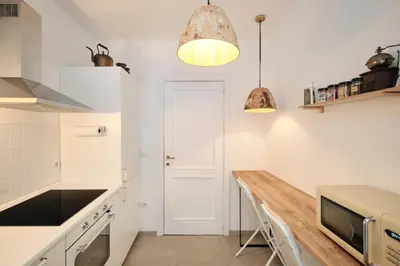 a kitchen with white counters and a wooden counter top at Basilica San Paolo - Luxurious penthouse with Wi-Fi in Rome