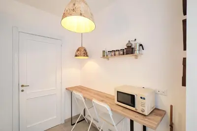 a kitchen with a table with a microwave on it at Basilica San Paolo - Luxurious penthouse with Wi-Fi in Rome