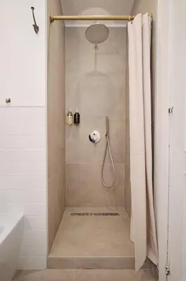 a shower with a shower curtain in a bathroom at Basilica San Paolo - Luxurious penthouse with Wi-Fi in Rome