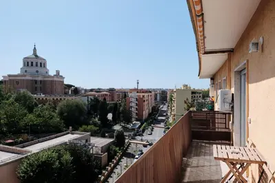 a view of a city from a balcony of a building at Basilica San Paolo - Luxurious penthouse with Wi-Fi in Rome