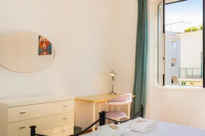 a bedroom with a desk and a window at Jenner Apartment by Rental in Rome in Rome