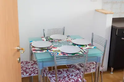 a blue table with chairs and wine glasses on it at Jenner Apartment by Rental in Rome in Rome