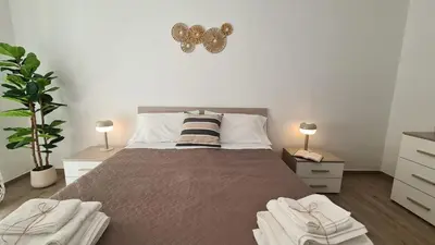 a bedroom with a large bed with two night stands at LoveRhome Apartment 14 in Rome