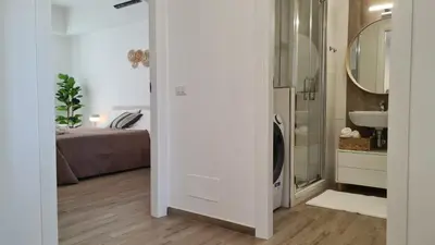 a bathroom with a shower and a sink and a bed at LoveRhome Apartment 14 in Rome