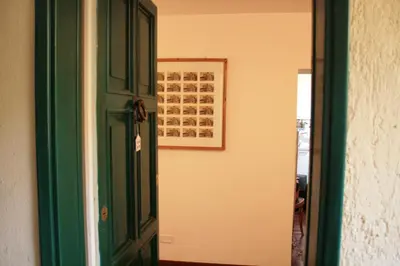 a green door in a room with a picture on the wall at Baccina cozy apartment in Rome