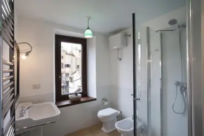 a bathroom with a toilet and a sink and a shower at Laurina F3 terrace for family - LOCAPPART in Rome