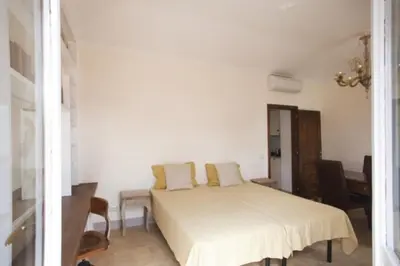 a bedroom with a white bed with yellow pillows at Laurina F3 terrace for family - LOCAPPART in Rome