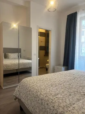 a bedroom with two beds and a mirror at PORTA FURBA Suites in Rome
