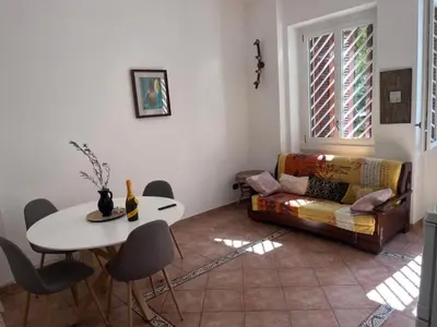a living room with a couch and a table at Holiday home Roma Night and Day in Rome