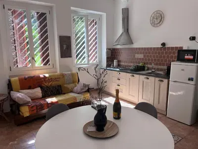 a kitchen with a table with a bottle of wine on it at Holiday home Roma Night and Day in Rome