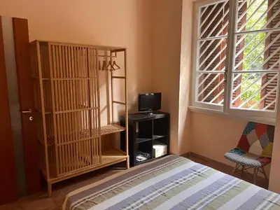 a bedroom with a bed and a tv and a window at Holiday home Roma Night and Day in Rome