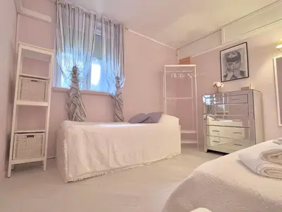 a bedroom with two beds and a window at Vacanze Romane a San Giovanni in Rome