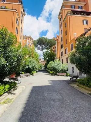 a street with benches and buildings in a city at Vacanze Romane a San Giovanni in Rome