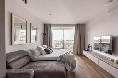 a living room with a couch and a large window at The Best Rent - Spacious three-bedroom flat in the San Giovanni area in Rome