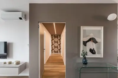 a room with a glass table and a hallway at The Best Rent - Spacious three-bedroom flat in the San Giovanni area in Rome