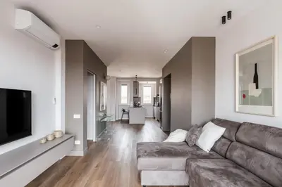 a living room with a couch and a television at The Best Rent - Spacious three-bedroom flat in the San Giovanni area in Rome