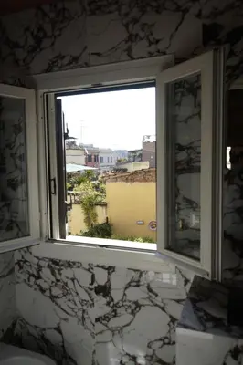 a window in a bathroom with a view of a city at Restart Accommodations Colonna e Ludovisi in Rome