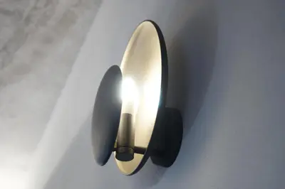 a light on a wall with a light on it at Restart Accommodations Colonna e Ludovisi in Rome