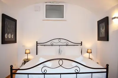 a bedroom with a large bed with two lamps at Appartamento a Piazza Navona in Rome