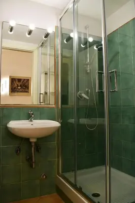 a bathroom with a sink and a glass shower at Appartamento a Piazza Navona in Rome
