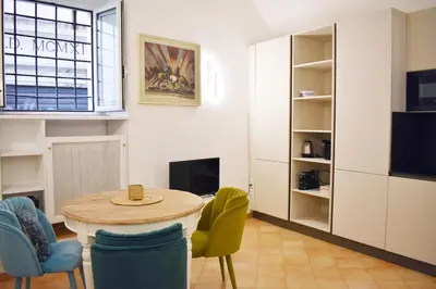 a living room with a table and chairs at Appartamento a Piazza Navona in Rome