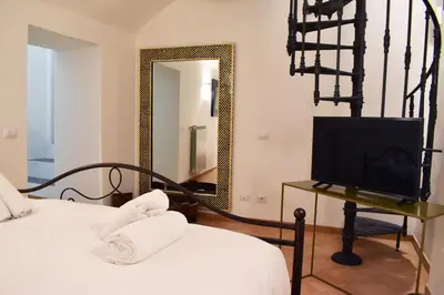 a bedroom with a bed and a mirror and a television at Appartamento a Piazza Navona in Rome