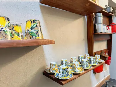 a row of blue and white cups on a shelf at Nice 2 CU in Rome
