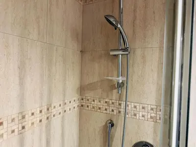 a shower with a shower head in a bathroom at Nice 2 CU in Rome