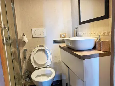 a bathroom with a toilet and a sink at Nice 2 CU in Rome