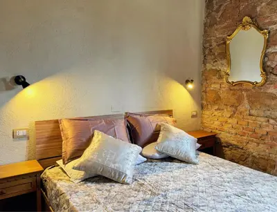 a bedroom with a bed with pillows and a mirror at Nice 2 CU in Rome