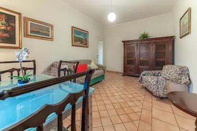 a living room with a glass table and chairs at Marta Suite - Metro Malatesta & Wi-Fi in Rome