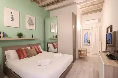 a bedroom with a large white bed in a room at Beautiful Apartment in the Heart of Rome in Rome