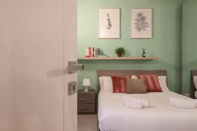 a bedroom with two beds with green walls at Beautiful Apartment in the Heart of Rome in Rome